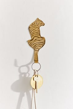 an animal keychain is hanging on the wall