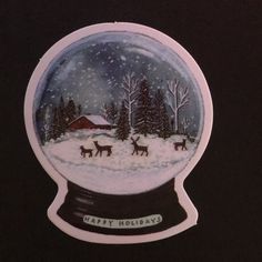 there is a snow globe with reindeers in it on the black background and merry holidays