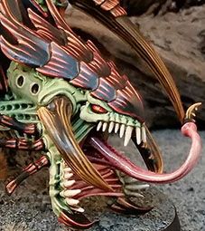 a close up of a toy figurine on a table with rocks in the background