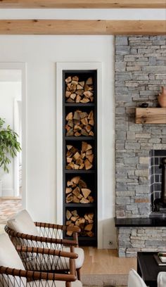 a living room filled with furniture next to a fire place and a stone fireplace mantel