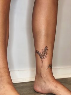 a woman's foot with a small tattoo on the side of her left leg