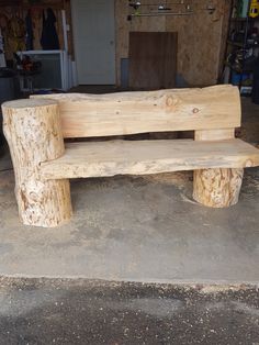 a wooden bench sitting in the middle of a garage