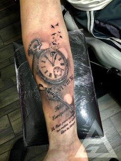 a person with a clock tattoo on their arm