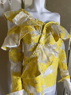 "White and yellow silk organza asymmetrical blouse with off shoulder and covered button detail. Modern size 6 and gorgeous! Bust is 34\", waist 29/30\"." One-shoulder Silk Top For Spring, Spring Silk Off-shoulder Blouse, Off-shoulder Silk Blouse For Spring, One-shoulder Silk Blouse For Party, Fitted Blouse With Asymmetrical Neckline For Formal Occasions, Elegant One-shoulder Silk Blouse, Elegant One Shoulder Silk Blouse, Chic Yellow One-shoulder Top, Elegant Yellow Formal Tops