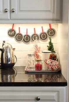 the kitchen counter is decorated for christmas with red and white candy canes on it