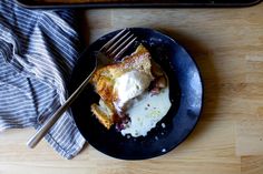 a piece of cake on a plate with a fork next to it and a baking pan in the background