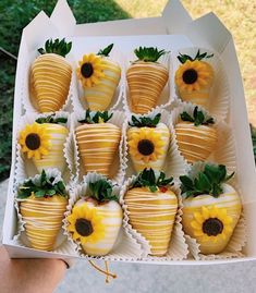 a box filled with chocolate covered strawberries and sunflowers on top of each other