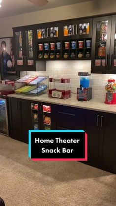 a home theater snack bar with snacks on the counter and shelves behind it that are filled with sodas