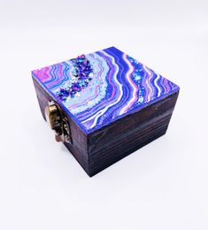 a small wooden box with colorful designs on it