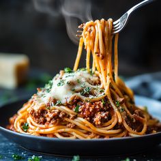 a fork full of spaghetti with meat sauce and parmesan cheese