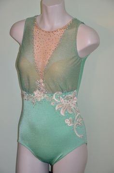 a mannequin wearing a green leotard with beading on it's chest