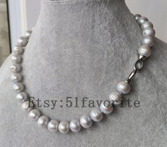 Jewelry: fresh water pear, genuine cultured pearl,Baroque pearl Color: gray Grade: A+, have beautiful natural blemish and rings on pearl's surface Size: about 10-11.5mm; error range: ±0.5mm Shape: near round, not so round Length: offer different length Handwork: knotted Metal: alloy, Shipping: I will send out your order in 1-5 business days. Usually will take about 20-50 business days.  Best regards! Gray Round Necklace For Formal Occasions, Elegant Gray Round Pearl Necklace, Gray Pearl Necklace For Formal Occasions, Formal Gray Pearl Necklace, Gray Round Pearl Jewelry, Gray Single Strand Pearl Necklace As Gift, Gray Single Strand Jewelry As Gift, Gray Single Strand Jewelry As A Gift, Pearl Baroque