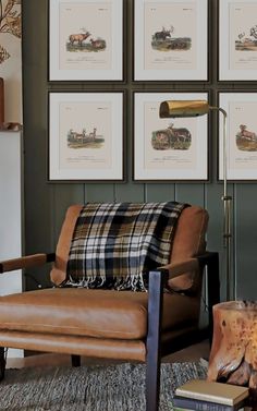 a living room filled with furniture and framed pictures on the wall above it's fireplace