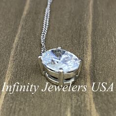 "The pendant pictured is a simulated diamond #6760 -Approximate total carat weight: approx. 3.00ctw diamond equivalent -Center Stone Size: 10x8mm - approx. 3.00ct diamond equivalent -Center Stone Shape: oval -Gem Type: simulated diamond -Stone Clarity: VVS1 -Stone Color: D -Moh's Scale: 8.5 hardness -Metal Type and Purity: 14k white gold -Setting: 4 prong basket head -Chain: 18\" delicate 14k gold chain / heavier option with lobster claw available (use dropdown to select) -Country of Manufacturi Dazzling Diamond White Oval Pendant Jewelry, Silver Solitaire Diamond Cut Oval Pendant Necklace, Oval Pendant Solitaire Necklace In Sterling Silver For Anniversary, White Oval Necklace With Prong Setting, Classic Silver Oval Solitaire Necklace, Silver Solitaire Necklace With Oval Pendant For Anniversary, Formal Solitaire Necklace With Oval Cubic Zirconia Pendant, Formal Cubic Zirconia Solitaire Necklace With Oval Pendant, Oval Solitaire Necklace For Anniversary