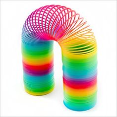 a stack of multicolored spirals sitting on top of each other in front of a white background