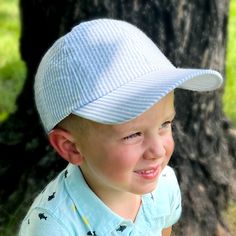 The hat we can barely keep in stock!! This Seersucker Ball Cap is the perfect way to keep your little one from getting too much sun while still letting them have some fun! With UPF 50+ protection, this cotton-poly blend seersucker cap helps ensure your toddler stays safe in the sun. Hat size: 2-4T Casual Adjustable Baseball Cap For Playtime, Casual Curved Brim Baseball Cap For Playtime, Casual Curved Brim Baseball Cap, Playful Cotton Hat With Upf 50+, Playful Cotton Hats With Upf 50+, Casual White Sun Hat For Playtime, Summer Baseball Cap With Upf 50+ For Spring, Spring Baseball Cap With Upf 50+ And Curved Brim, Spring Curved Brim Baseball Cap With Upf 50+