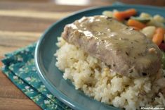 a blue plate topped with meat covered in gravy