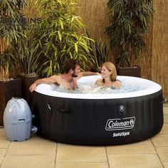 a man and woman relaxing in an outdoor hot tub