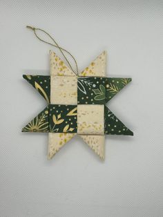 a green and white ornament hanging from a string