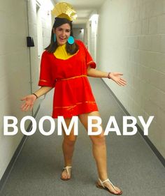 a woman in a red dress and yellow hat is walking down a hallway with the words boom baby on it