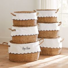 four baskets stacked on top of each other with the name dry cleaning written on them