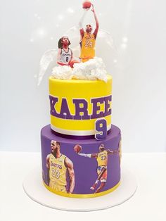 a three tiered cake decorated with lakers memorabilia