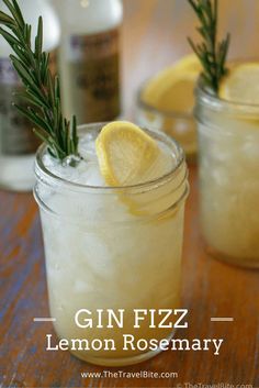 the gin fizz lemon rosemary cocktail is garnished with fresh rosemary and served in mason jars