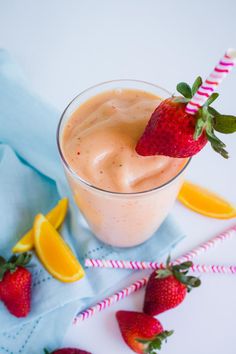 a drink with strawberries and lemons on the side