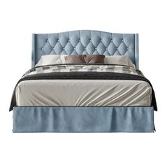 a bed with blue upholstered headboard and pillows