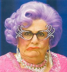 an older woman with purple hair and glasses