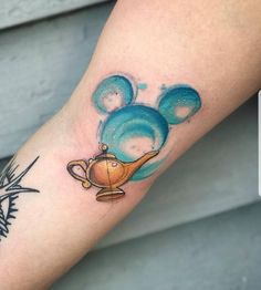 a tattoo on the arm of a person with a teapot and bubbles in it