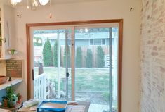 a room with a sliding glass door that leads to a back yard