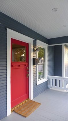 a red front door on a blue house