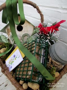 a bird house with green ribbon and flowers in it