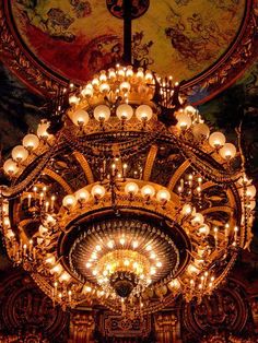 an ornate chandelier hangs from the ceiling