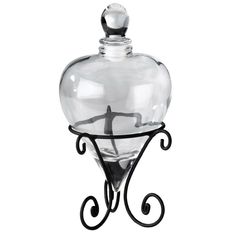 a glass bottle with a wrought iron stand