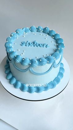 a blue and white cake with the word sister on it's top is sitting on a plate