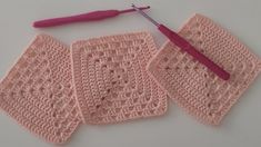 crocheted dishcloths with a pink handle are on a table next to an object that appears to be knitting