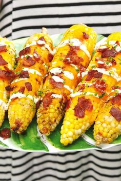 corn on the cob with pepperoni, cheese and other toppings in a platter