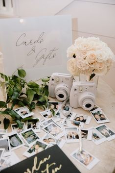 a table topped with pictures and flowers next to a sign