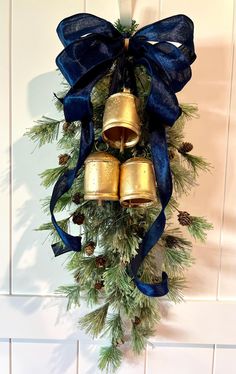 a christmas wreath with bells hanging from it