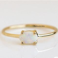 "Most Welcome to \"TheJewelryArts\" Products Description Center Stone: Genuine White Opal  Center Stone Size: 7x5mm Stone Shape: Oval Cabochon Stone Clarity: VVS Material: 92.5 Sterling Silver, also available in 24k Rose Gold Vermeil/Gold Vermeil/Black Vermeil Stamp: 92.5 ➽OCCASION: Surprise your loved one with this beautiful engagement/wedding jewelry by TheJewelryArts . A classic piece of jewelry for all men/women in your life, this is a perfect gift for any occasion such as birthdays, anniversaries, wedding, engagements, Valentine's Day or Christmas day mother's day. ✔Comfort Fit ✔Nickel Free ✔Free Engraving ✔ Free Shipping ✔  Ready to Ship in 3 Business Day Customization is always welcome and please feel free to contact with me if you have any design ideas! If you have any other query Minimalist White Opal Birthstone Ring, Oval Opal Birthstone Ring For Gift, White Minimalist Opal Birthstone Ring, Minimalist Oval Opal Ring In 14k Gold, Yellow Gold Opal Birthstone Ring, Oval Shape, Dainty Opal Ring, Gold Opal Ring, October Birthstone Ring, October Birthstone Rings