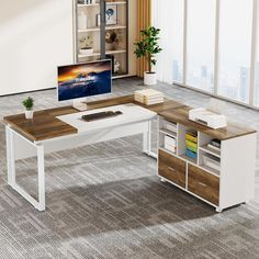 a computer desk with a monitor and keyboard on it in an empty room next to large windows