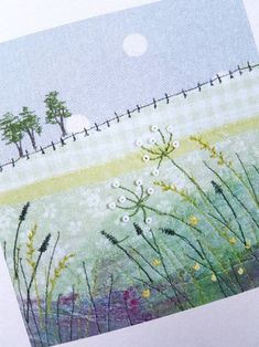 an image of a field with flowers and trees in the background on a piece of paper