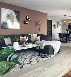 a living room filled with lots of furniture next to a dining room table and chairs