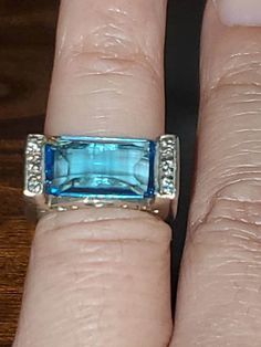 Hi buyers You are purchasing a Stunning topaz ring  in its rich, cool toned color ring is a vintage, stylish take on the traditional cocktail ring. The pale blue rectangular blue topaz is flush set in the polished sterling silver band with beautiful heart shape around the stone As a middle finger ring it will command attention, but it could also be worn as an alternative to the traditional engagement ring   blue topaz #02122 Luxury Silver Rectangular Topaz Ring, Luxury Topaz Ring With Rectangular Stone, Luxury Topaz Ring With Rectangular Gemstone, Luxury Rectangular Topaz Ring For Anniversary, Luxury Elegant Square Cut Topaz Ring, Luxury Blue Topaz Ring With Rectangular Stone, Traditional Engagement Ring, Topas Ring, Engagement Ring Blue