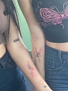 two women with matching tattoos on their arms