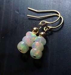 Handmade natural Fire Opal earrings, gemstone dangles, gold hooks, petite jewelry.  Genuine stones are opaque, 6 mm in diameter, flushing with colorful hues of yellow, pink, green, orange.  These earrings look beautiful, better than on photos.  Perfect for those who are born in October. French hooks are handmade with 12k gold fill wires. You will get the same as on the photos earrings.  The earrings are about 1 inch long.  A matching necklace https://etsy.me/2YKulVu  or bracelet are  available t Teardrop Opal Earrings In Gold, Gold Jewelry With French Hook And Round Beads, Gold Opal Drop Earrings, Petite Jewelry, Born In October, Fire Opal Earrings, Petite Earrings, Gold Hooks, Cleaning Silver Jewelry