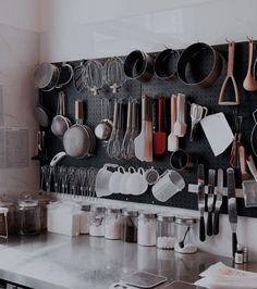 pots and pans are hanging on the wall