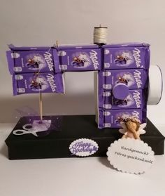 a purple sewing machine sitting on top of a table